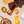 Load image into Gallery viewer, Espresso negroni bottle placed on a picnic blanket beside peeled citrus fruit, a decorative cup, and a bowl of food.