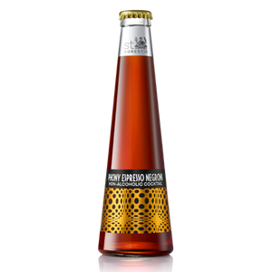 Virgin espresso negroni bottled non-alcoholic cocktail in a tall amber glass with gold and black patterned label.