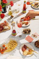 A crowded dinner table with St. Agrestis non-alcoholic cocktails
