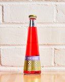 St. Agrestis Phony Negroni bottle against white brick wall