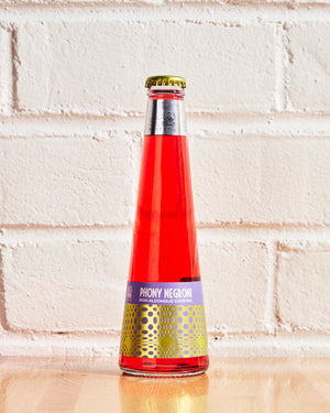 St. Agrestis Phony Negroni bottle against white brick wall