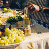 Phony White Negroni on a lunch table with green grapes